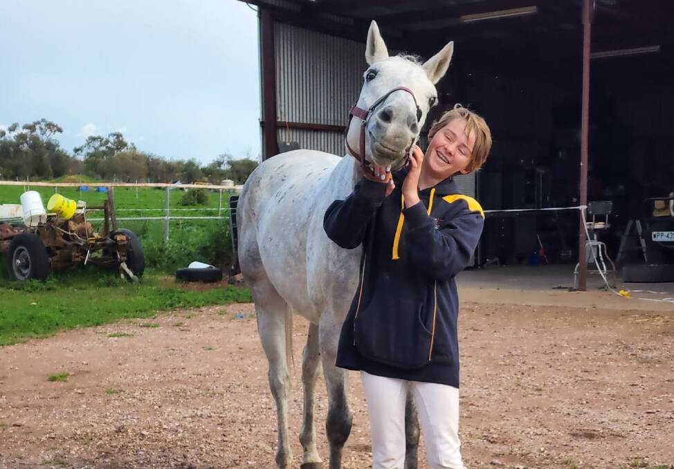 Montana Evans was delighted to see her horse Lucky Assassin at home in Leeton once again. Picture supplied.