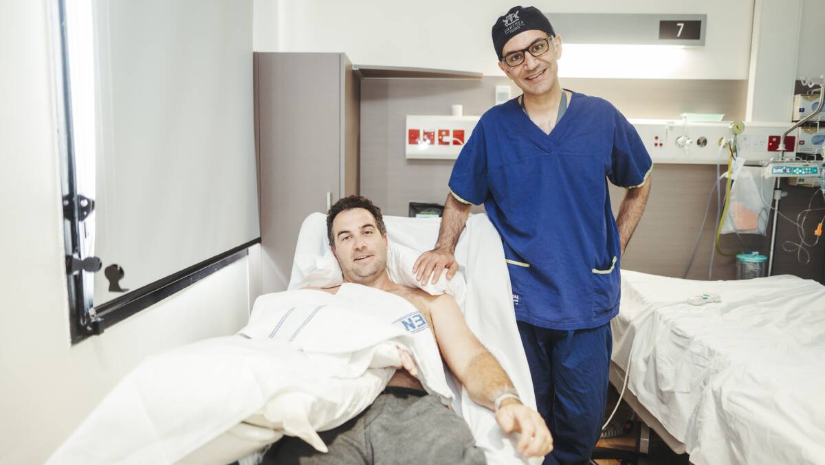 Wagga Wagga farmer Adam Symons with plastic surgeon Dr Ross Farhadieh after the latest 10-hour microsurgery to restore function to his right hand and forearm. Picture: Dion Georgopoulos 