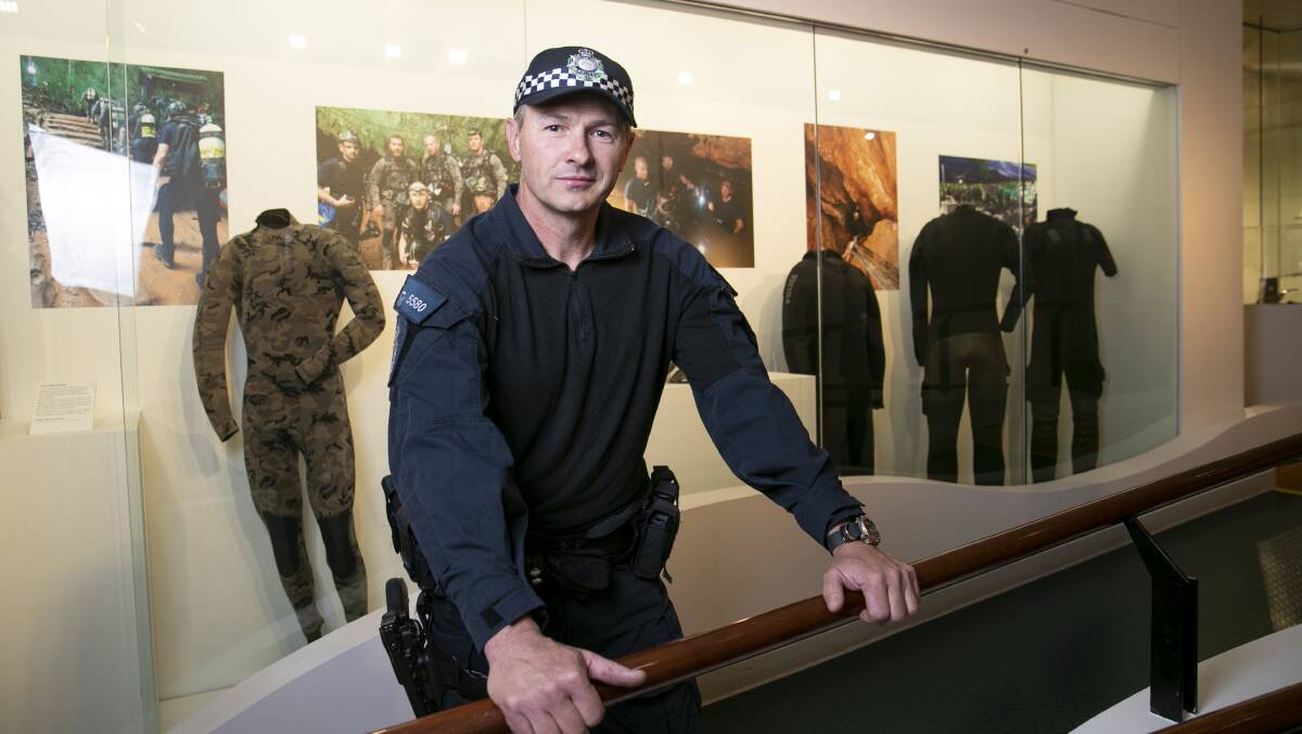 Detective Senior Constable Chris Markcrow with the dive exhibits from the Thai cave rescue. Picture: Keegan Carroll