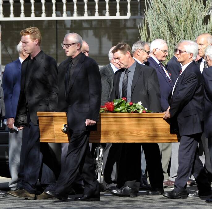 FINAL FAREWELL: Roger Clements' casket is carried out to the hearse following his funeral on Friday. Picture: Les Smith