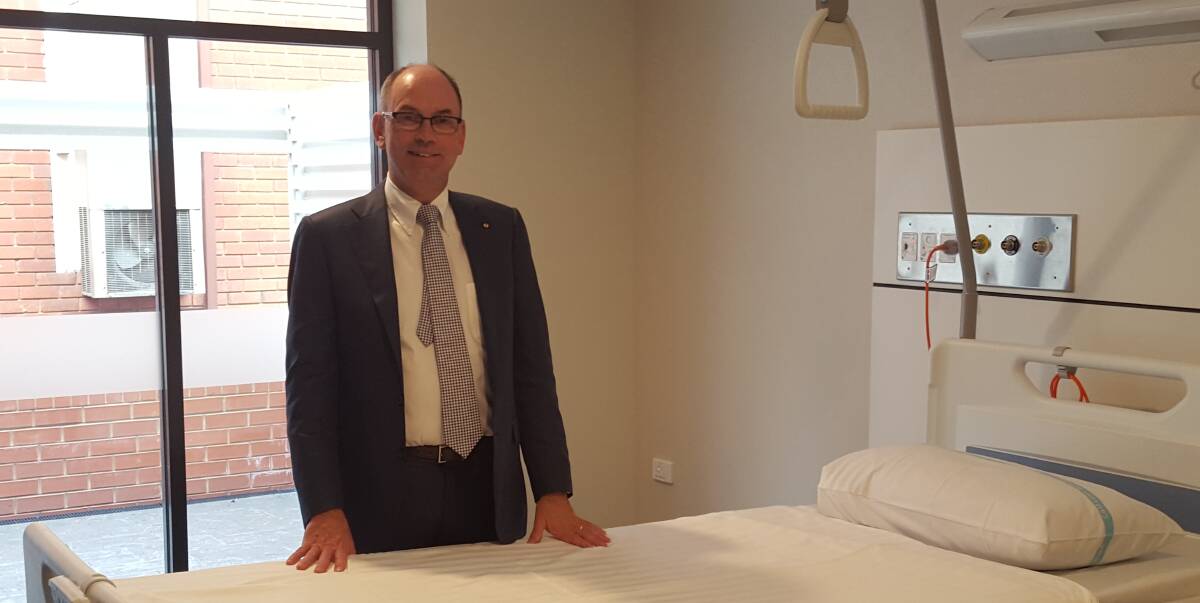 BRAND NEW: Cardiologist Gerard Carroll, part of the Wagga Palliative Care Alliance, inspects one of the new beds inside the Calvary palliative care unit that opened on Tuesday. Picture: Alex McConachie