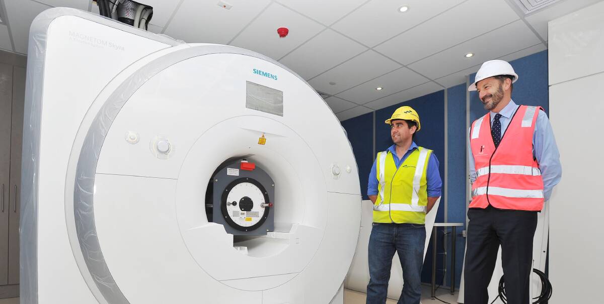 NEW TOYS: Hansen Yuncken project manager Michael Martin and Wagga Base Hospital general manager Denis Thomas inspect the new $2.7 million MRI machine. Picture: Kieren L Tilly