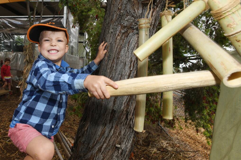 HAVING FUN: Harvey Pavitt, 4, plays some tunes on the musical instruments in the nature playground. 