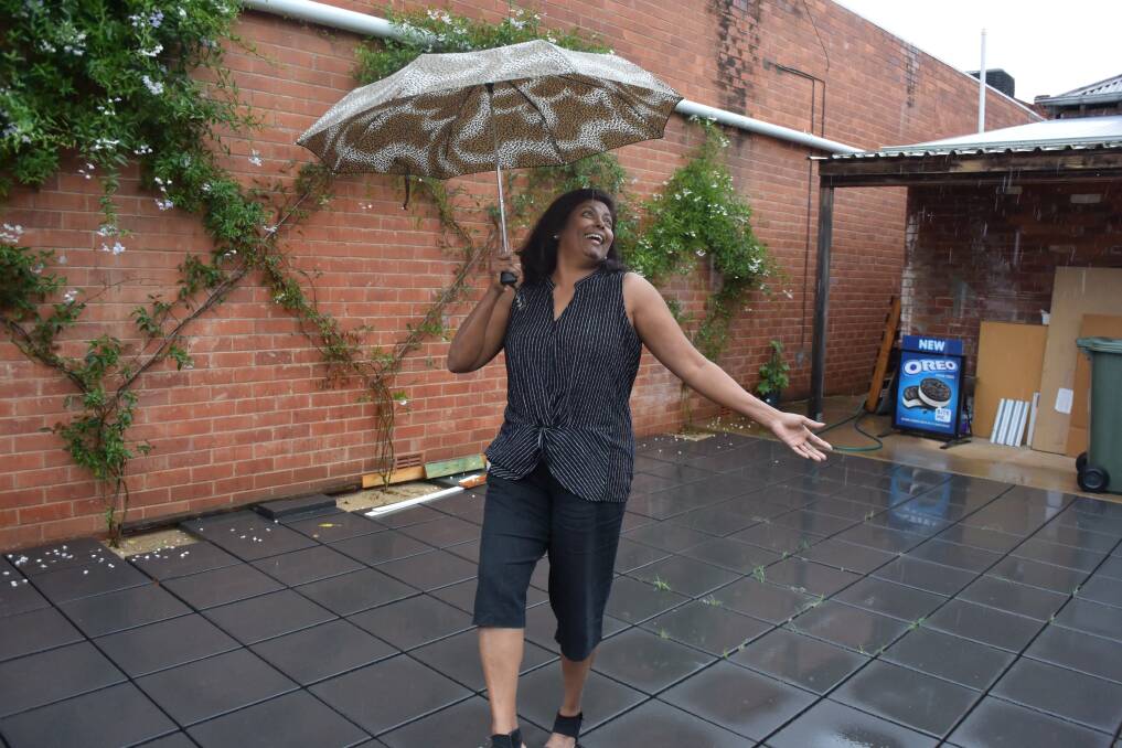 DANCING IN THE RAIN: Sheila Reynolds is happy to see the rain despite it putting a halt to some renovations. Picture: Annie Lewis 