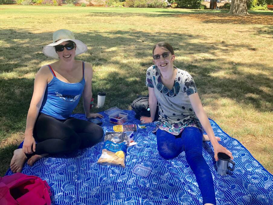 ENJOYING THE SUNSHINE: Heather Shaw and Natalie Cook enjoy a mid-week picnic at the Botanic Gardens. Picture: Annie Lewis 