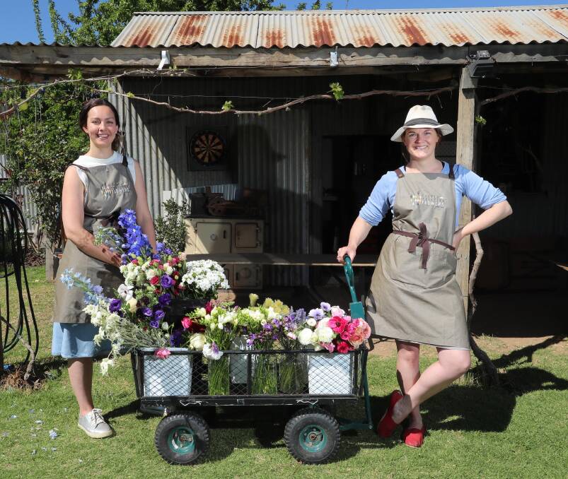 SPRINGTIME FLOWERS: Bethany Saab and Sophie Kurylowicz both have a passion for floral arrangements and gardening. Picture: Les Smith 