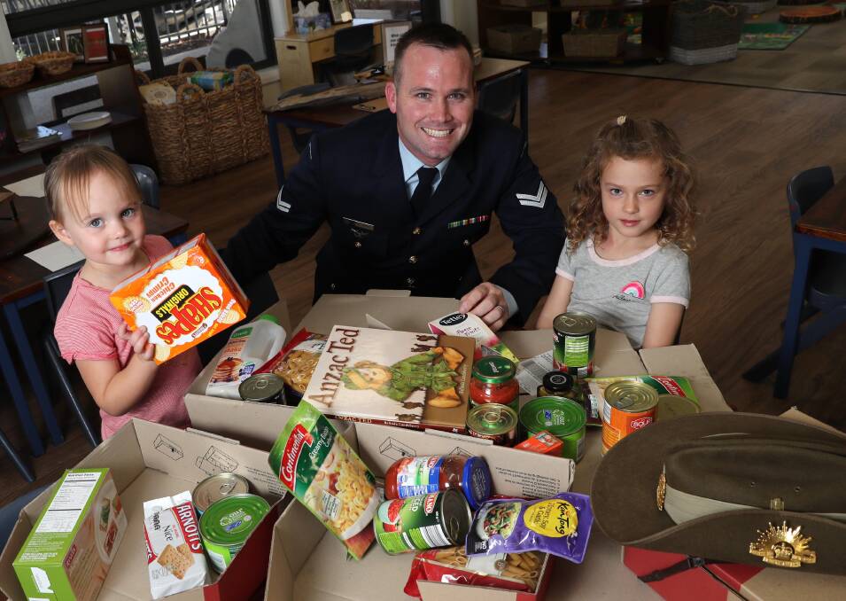 SURPRISE MAIL: Amelia Bagley, 3, Corporal Grant Hibbins and Taliia Furner, 5, put together the care packages. Picture: Les Smith
