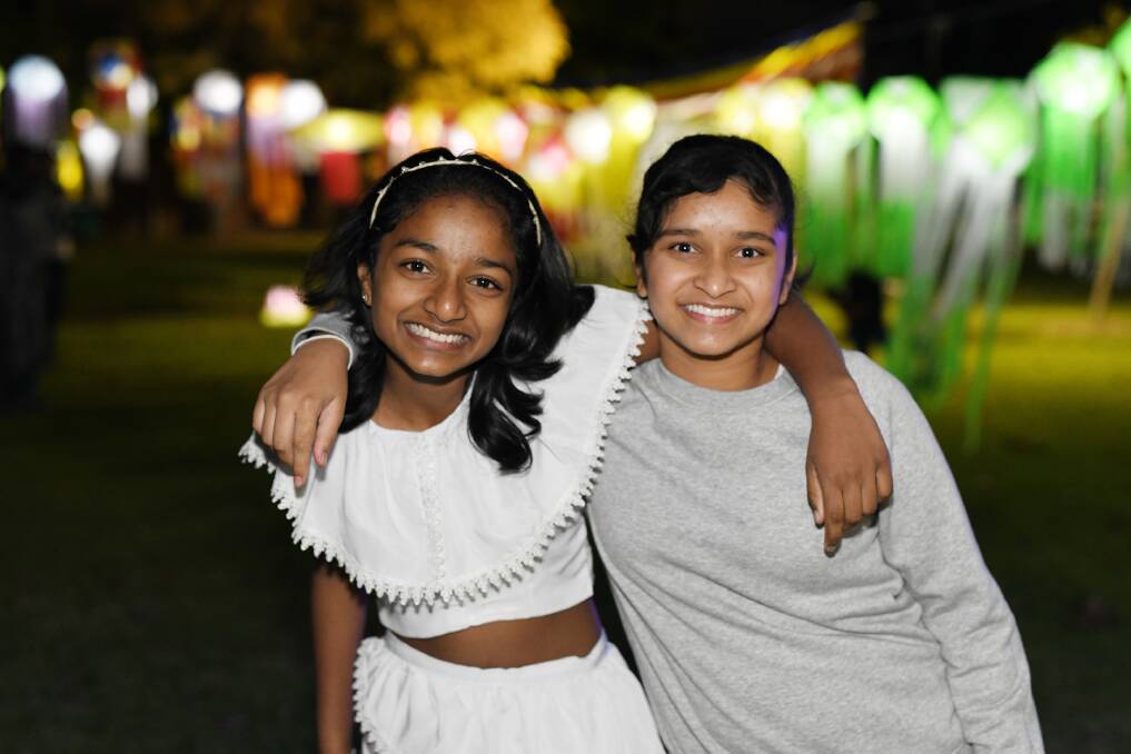 ALL SMILES: Dinara Piyasiri, 12, and Nethukee Jayasekera, 11, enjoy celebrating Vesak together. 