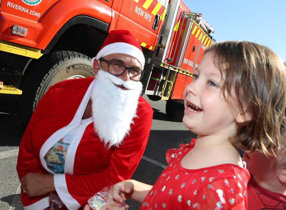 TIME TO CELEBRATE: Santa with Tanika Hodgkins, 5. Picture: Les Smith 