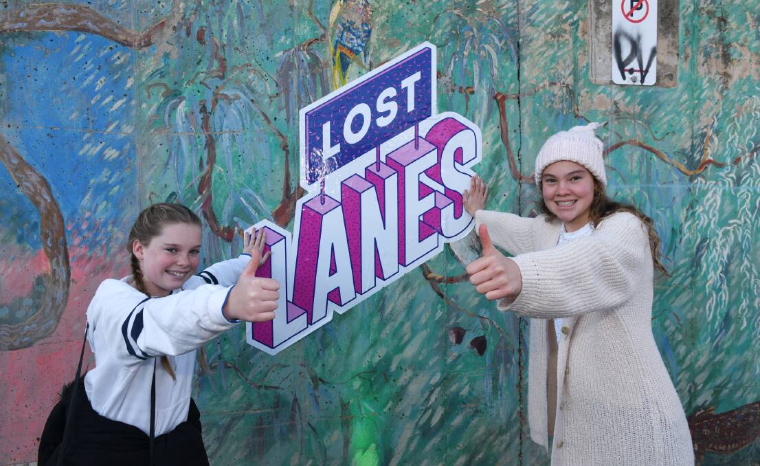 HUGE THUMBS UP: Christine Quick, 12, and Elsie Russell, 12, having a blast at the Lost Lanes micro-festival and gave it the tick of approval. 