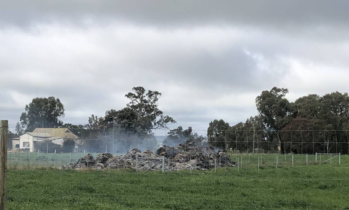 Hay stack still emits smoke off Gumly Road after catching alight on Saturday. 