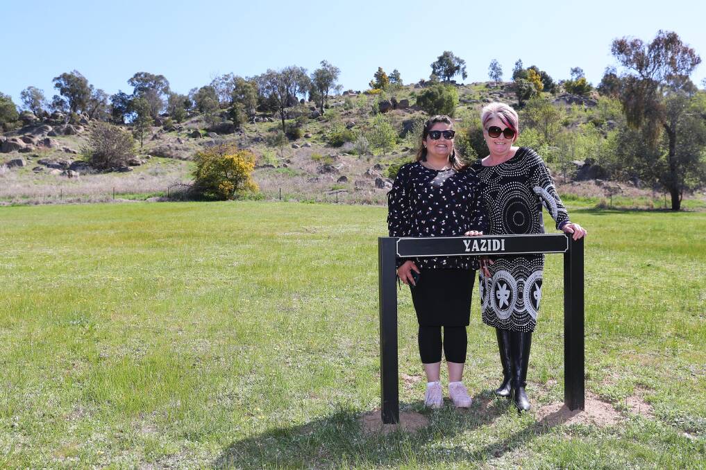 MILESTONE: Dalal Alhasan and Belinda Crain stand in front of the official Yazidi burial ground. Picture: Emma Hillier 
