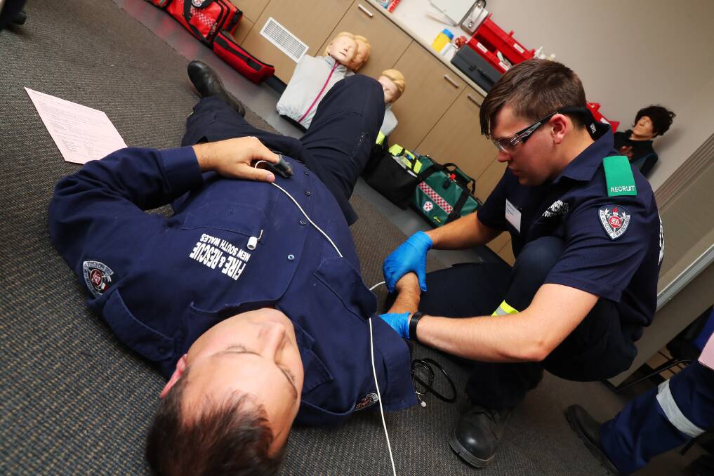 LEARNING THE STEPS: Stuart Forrest and Andrew Tassell simulate a medical emergency. Picture: Emma Hillier 