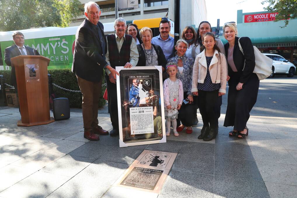 CELEBRATING AN ACHIEVEMENT: Cecil 'Bob' Scott receives a Walk of Honour plaque with his family and the Wagga Mayor Greg Conkey. Picture: Emma Hillier 