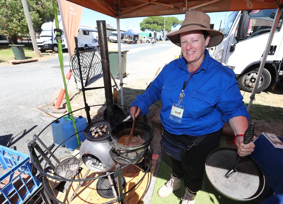 MASTER CHEF: Caron Pendergast proves to showgoers that you can still cook up a storm on camping equipment. Picture: Kieren L Tilly