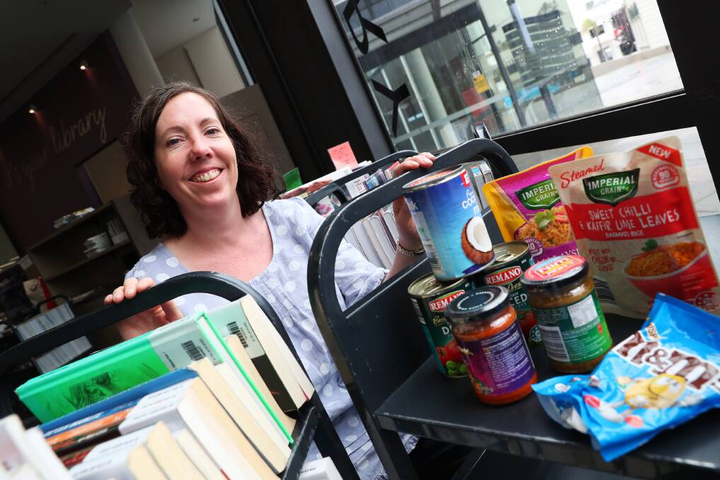 FOOD FOR FINES: Wendy Harper encourages people to drop into the library with a food donation to have their fines wiped. Picture: Emma Hillier 