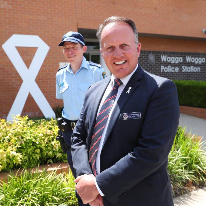 WHITE RIBBON: Senior Constable Matt Clipsham and Detective Inspector Phil Malligan are stepping up to help end violence against women. 
