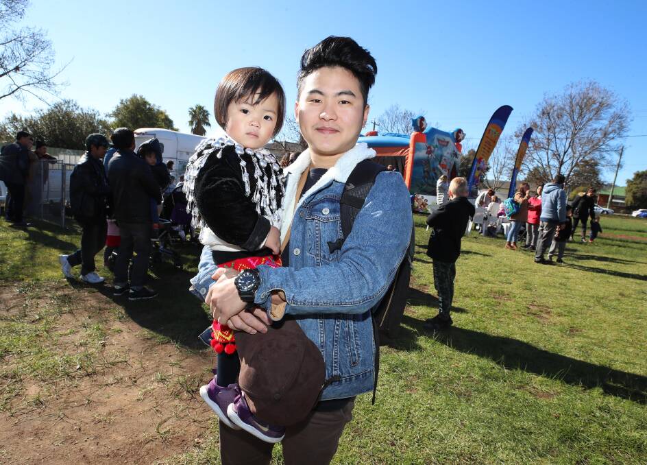 Phong Tiwangce with his sister Grace Tiwangce, 2, at the Refugee Week Family Fun Day. Picture: Les Smith 