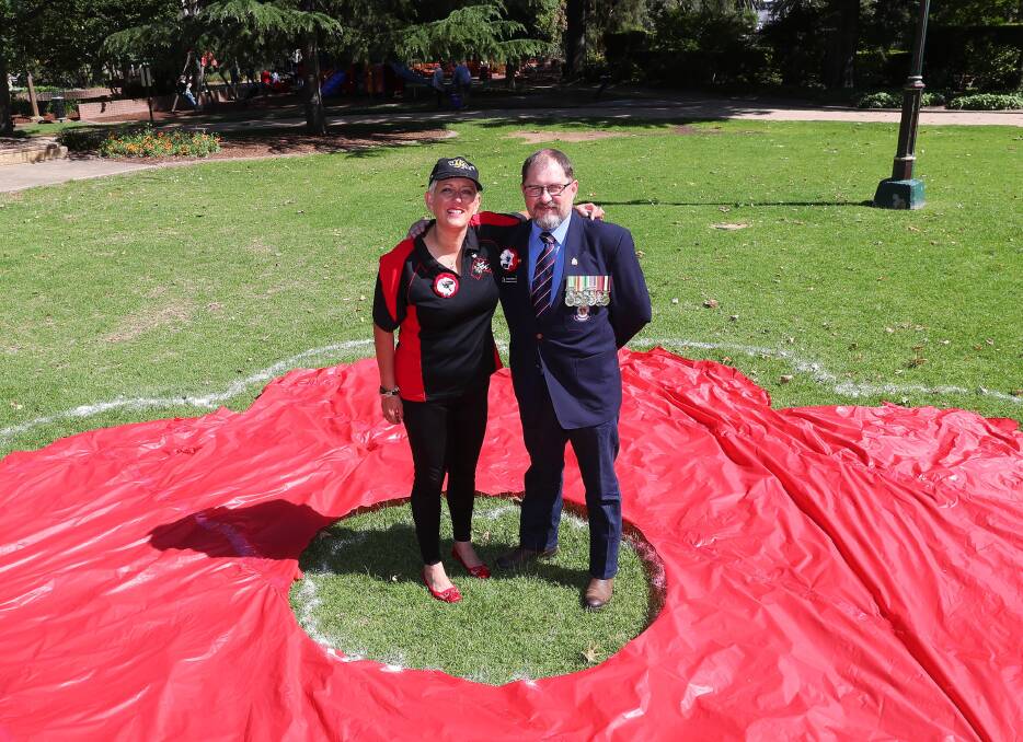 HONOURING REMEMBRANCE DAY: OJ Rushton and Richard Salcole standing in the outline of the poppy for Peace Project. Picture: Emma Hillier 