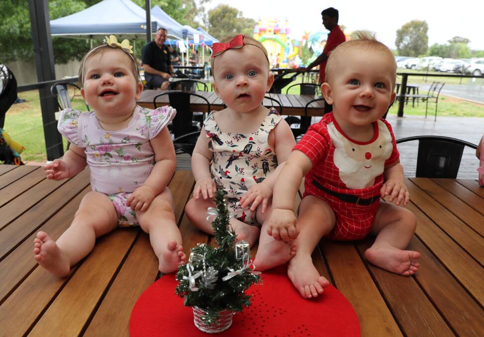 A MINI CHRISTMAS: Nora Sheather, 8 months, Ivy Hall, 8 months and Mataio Byrne, 7 months are having a blast together. Picture: Les Smith 