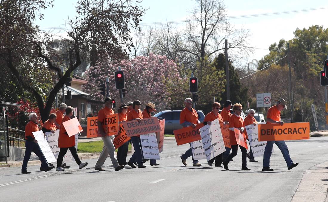 READY TO MARCH: Tumbarumba protesters outside Kooringal Public School at the Wagga byelection last year. Picture: Les Smith
