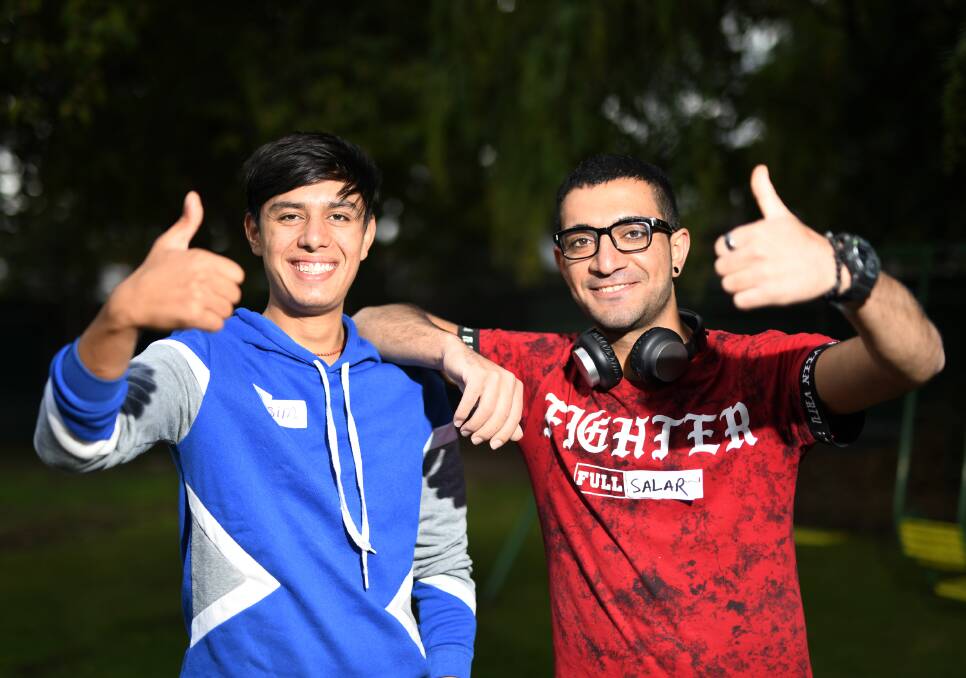ALL SMILES: Qasim Aoso and Salar Hasan enjoy the chance to socialise with other members of the Refugee Youth Mentoring Program. 