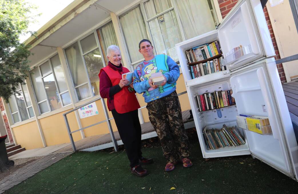 STREET LIBRARY: Jenny McNamara and Jodie Burns with the 'fridge of books' for the community. Picture: Les Smith 