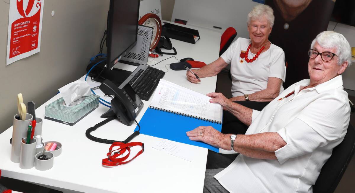 SELFESS DEDICATION: Wilma Arnold and Bev Amery are at the Red Cross Centre from 7.30am most mornings to begin making calls to their clients. Picture: Les Smith 