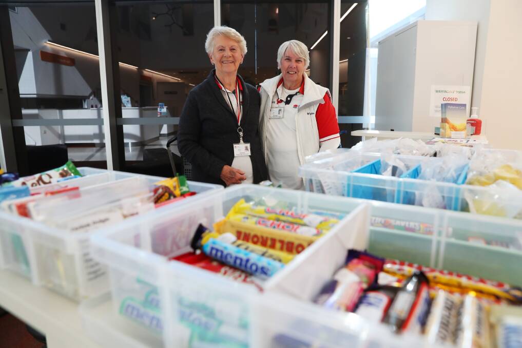 WITH A SMILE: Joyce Parish and Lise Chan enjoy being able to help out at Wagga Base Hospital. Picture: Emma Hillier 