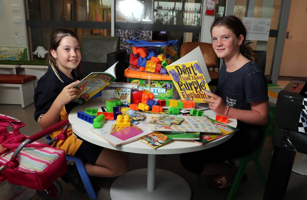 SELFLESS ACT: Claire Anschuetz,9, donates toys to the childrens' ward at Wagga Base Hospital. One recipient is Abbey Townsend, 11. Picture: Les Smith 