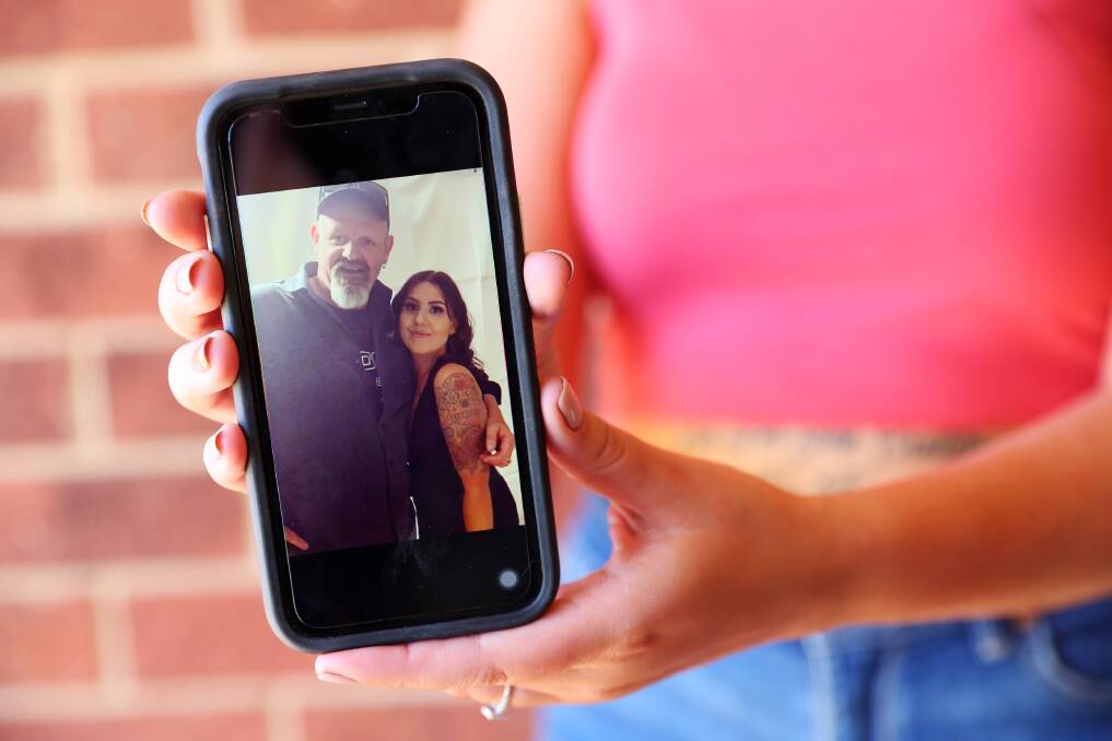 MEMORIES: Brittany Hackett holds one of the last photos taken with her dad, Mal Hackett, after he tragically died on Saturday. Picture: Emma Hillier 