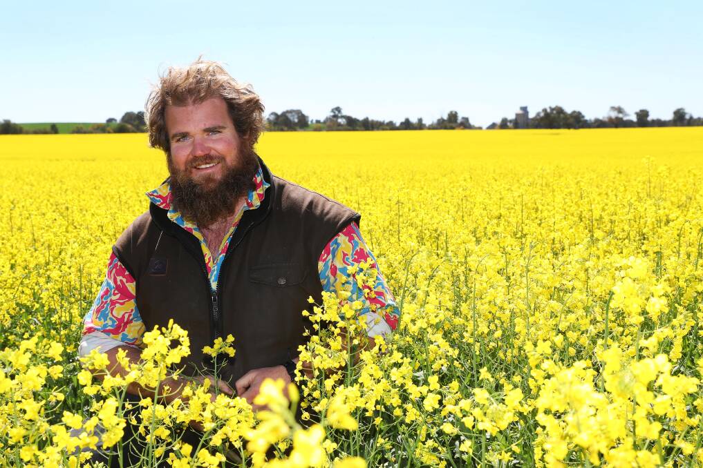 SEA OF YELLOW: Simon Moloney said he's grateful for how his crops so far. His colourful shirt is intended to be a conversation starter for mental health. Picture: Emma Hillier 
