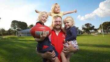 Henty forward Shannon Terlich with his three daughters Ruby, 7, Claire, 4 and Hazel, 2, ahead of his 200-match milestone on the weekend. Picture by James Wiltshire