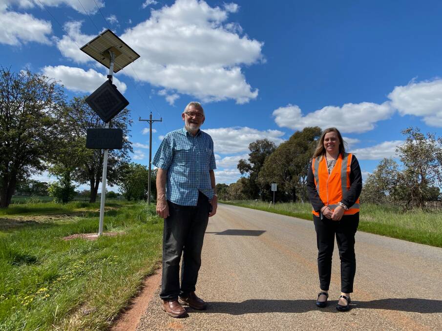 SAFETY: Leeton Shire Council mayor Paul Maytom with road safety officer Steph Puntoriero displaying the new signage, which is activated by vehicles on approach to the intersection. Photo: Talia Pattison