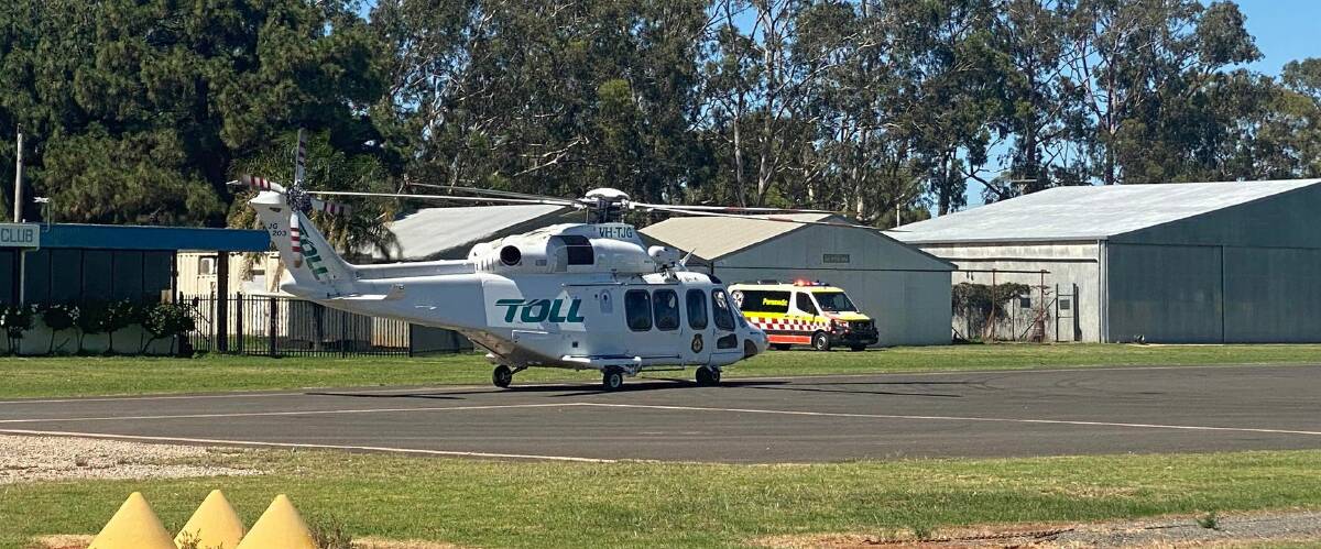 ASSIST: A helicopter and ambulance at the Griffith Airport this morning following the accident. PHOTO: Lizzie Gracie