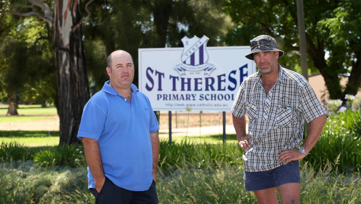 UP IN ARMS: Parents Gavin and Adrian Raccanello want St Therese Primary School Yenda to stay open. Picture: The Area News