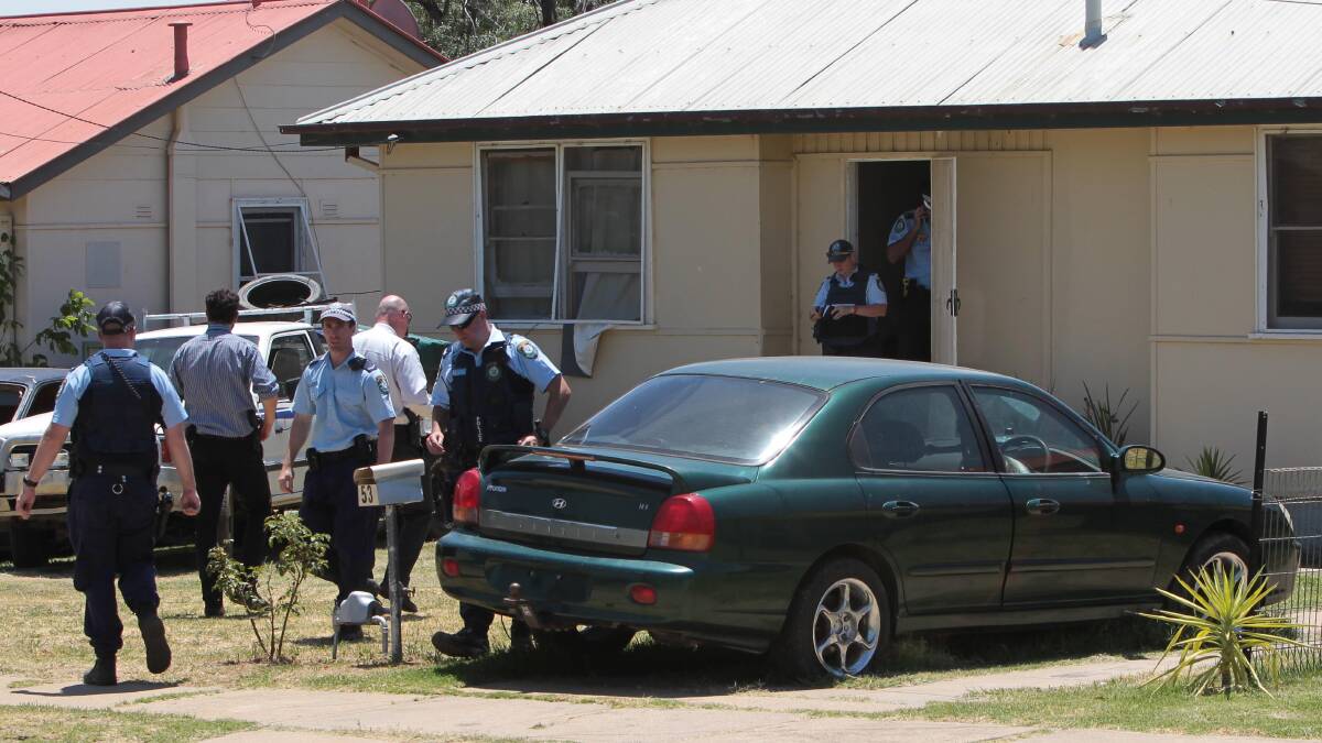 Police swoop a Mt Austin home after reports of shots fired.