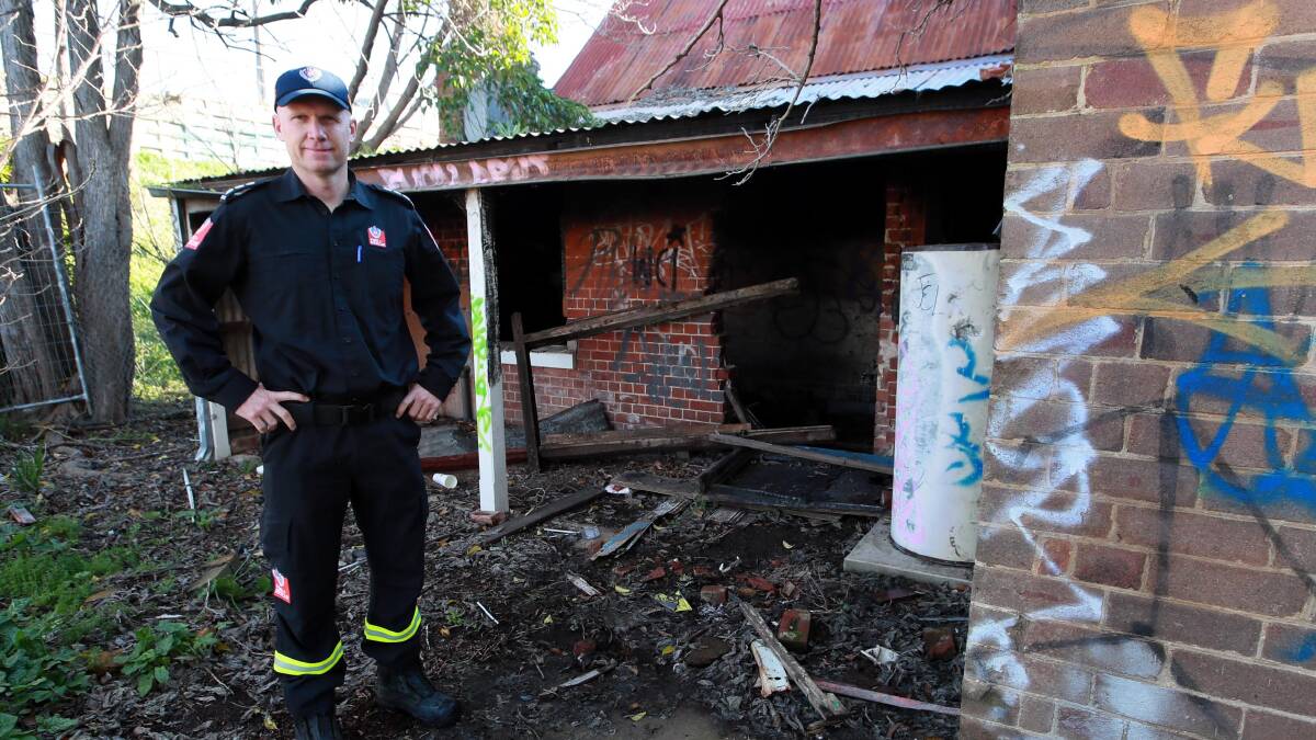 RUN DOWN: Turvey Park Fire and Rescue senior firefighter Chad Kennis standing outside the derelict building on Railway Street that was set on fire last weekend. Picture: Les Smith