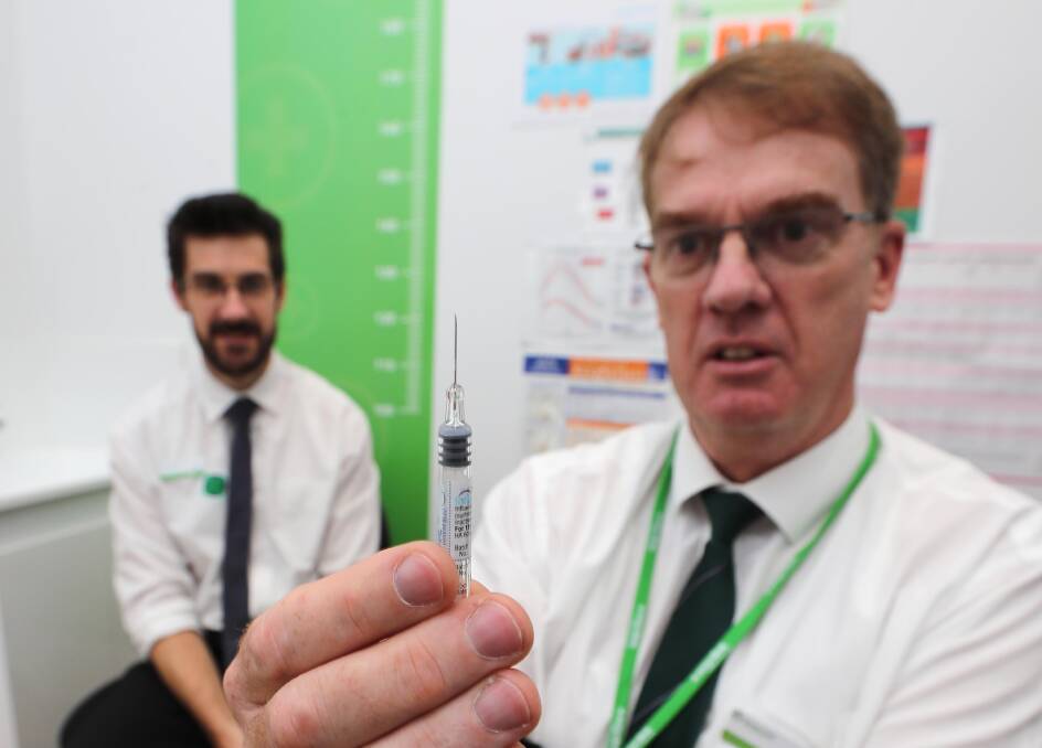 Pharmacist Michael O'Reilly gets ready for his flu jab. Picture: Les Smith