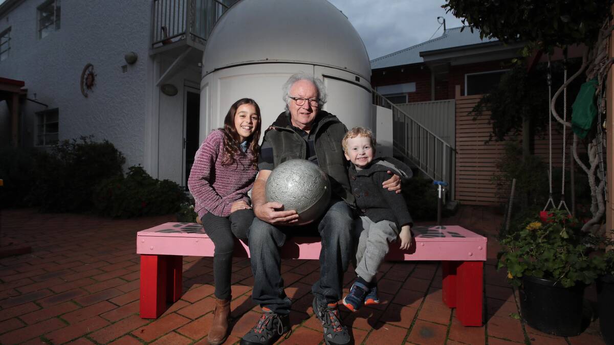 Wagga's Graeme White teaching his grandchildren Isobel and Felix Boland about the moon. Picture: Les Smith