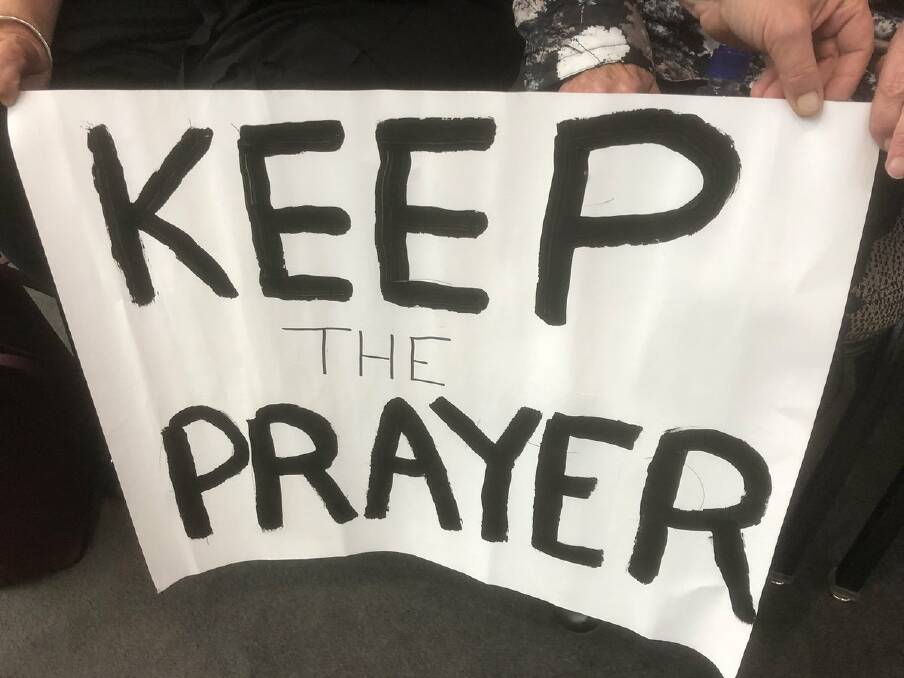 Protesters take a stand against council's idea to scrap prayer