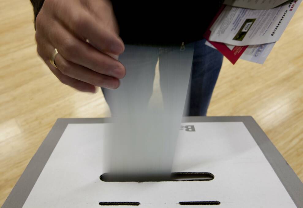 A resident casts their vote at the local government elections. 