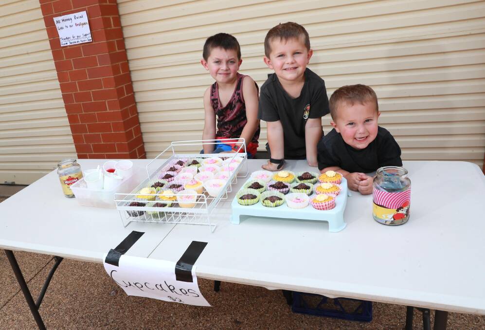 The Poulos children Jeremiah, Jyeron and Kylen selling cupcakes and jelly cups to raise money for the firefighters. Picture: Les Smith