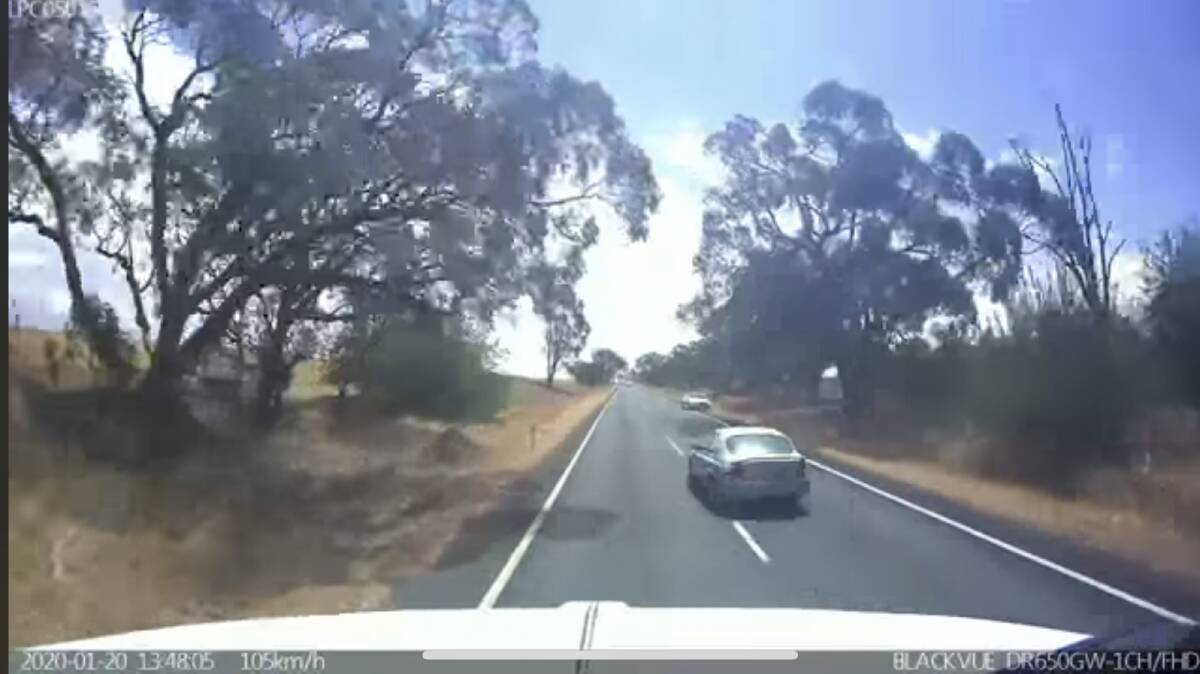 Dashcam footage of a vehicle overtaking a truck, but pushing a highway patrol car off the road in the process. 