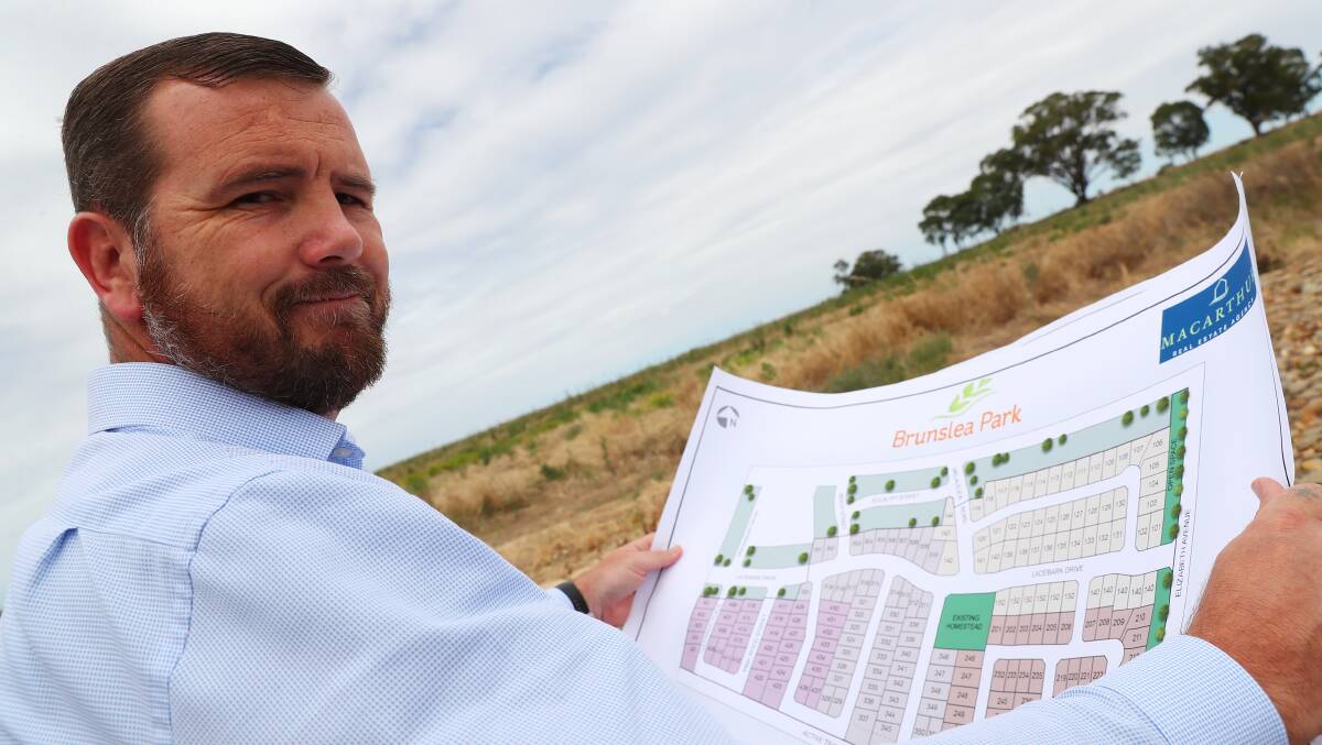 GREEN LIGHT: Macarthur Real Estate Agency director Mark Macarthur shows concept drawings of the residential development at Forest Hill, which will see hundreds of new homes in the suburb. Picture: Emma Hillier