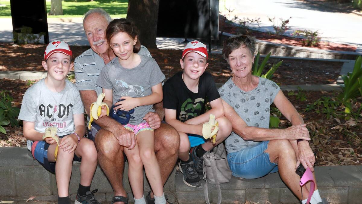 OUT IN THE SUN: Phil and Jenny Powell of Wagga enjoy the summer weather at the Botanic Gardens with their grandchildren Charlie, Anna and Sam Powell from Galston, Sydney. Picture: Les Smith