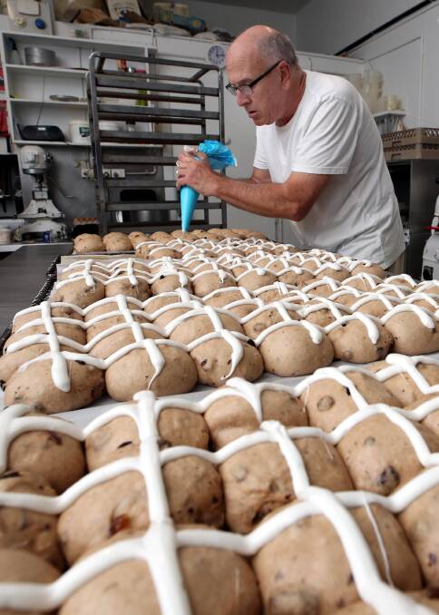 PIPING: Peter O'Brien of O'Brien's Hot Bake Bakery preparing hot cross buns for Easter. Picture: Les Smith