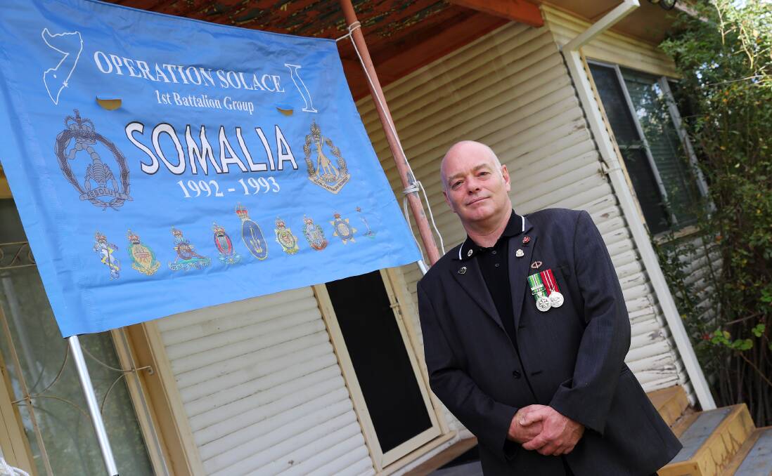 Somalia veteran Greg Seymour flying his Operation Solace banner for Anzac Day. Picture: Emma Hillier