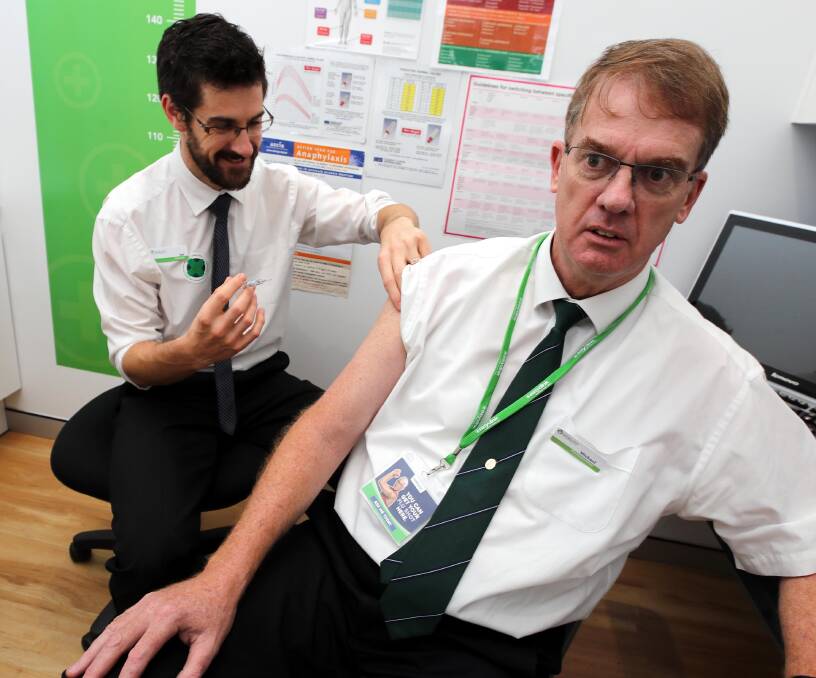 BEST DEFENCE: Pharmacist Michael O'Reilly receives the flu jab from fellow pharmacist Joe Madden at the Michael O'Reilly pharmacy. Picture: Les Smith