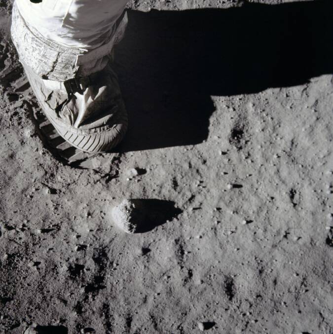 A close-up view of an astronaut's boot and bootprint in the lunar soil.